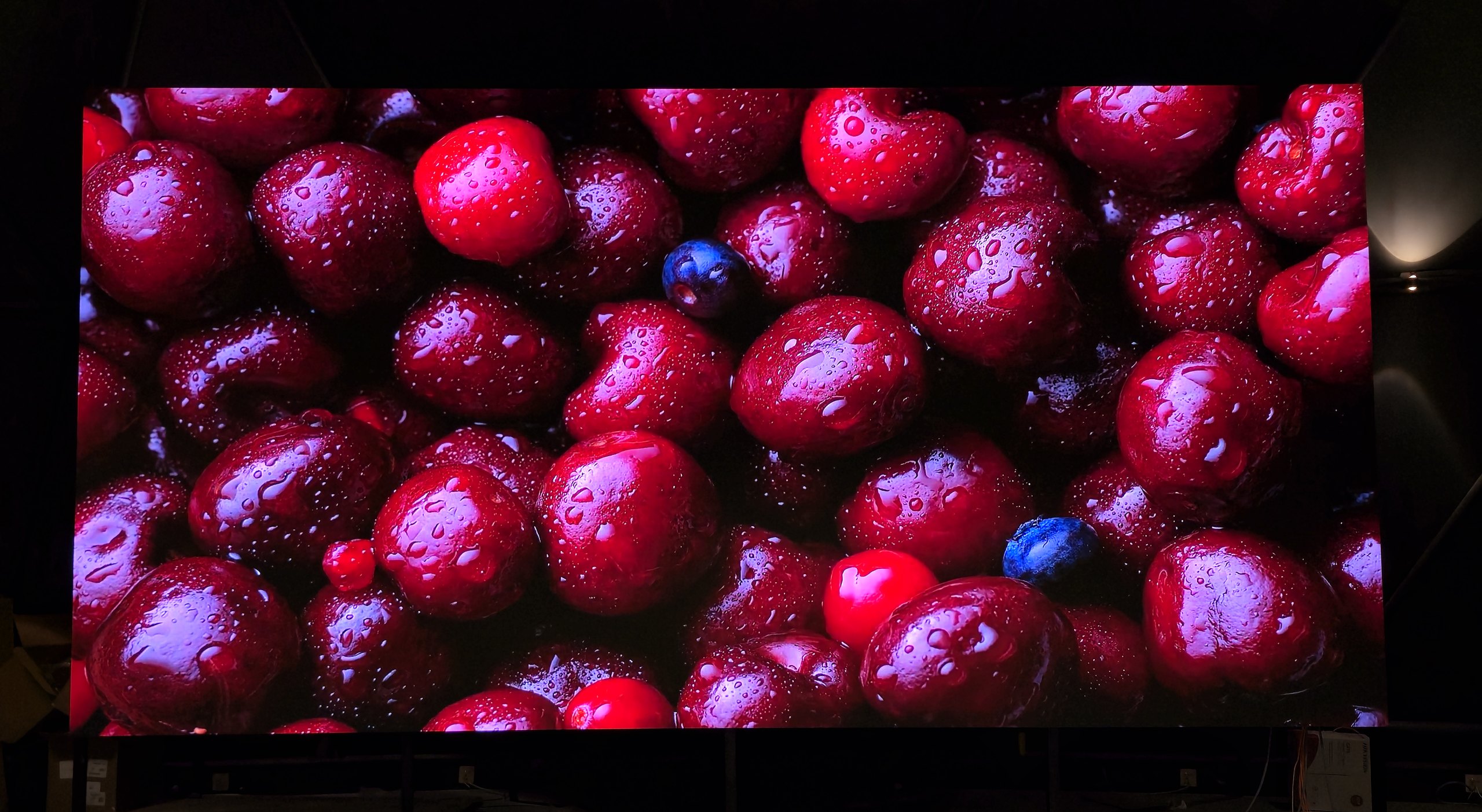 VANCOTT COB fine-pitch indoor LED wall showing a close-up of cherries, photographed in a dark room